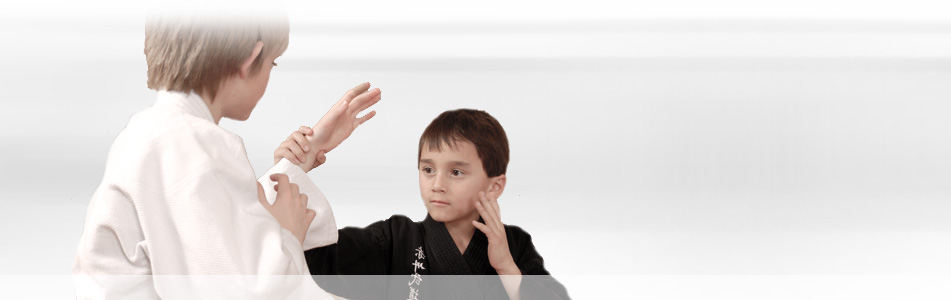 Two youth students practicing martial arts techniques at CAMA